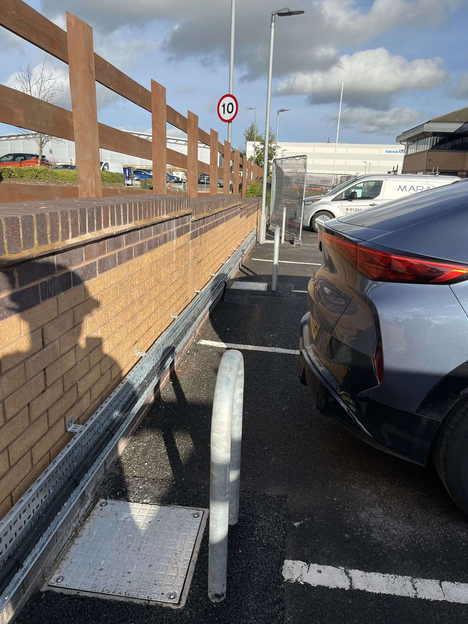 Commercial EV charge point commissioned alongside parked vehicles, installed by MARA Electrical