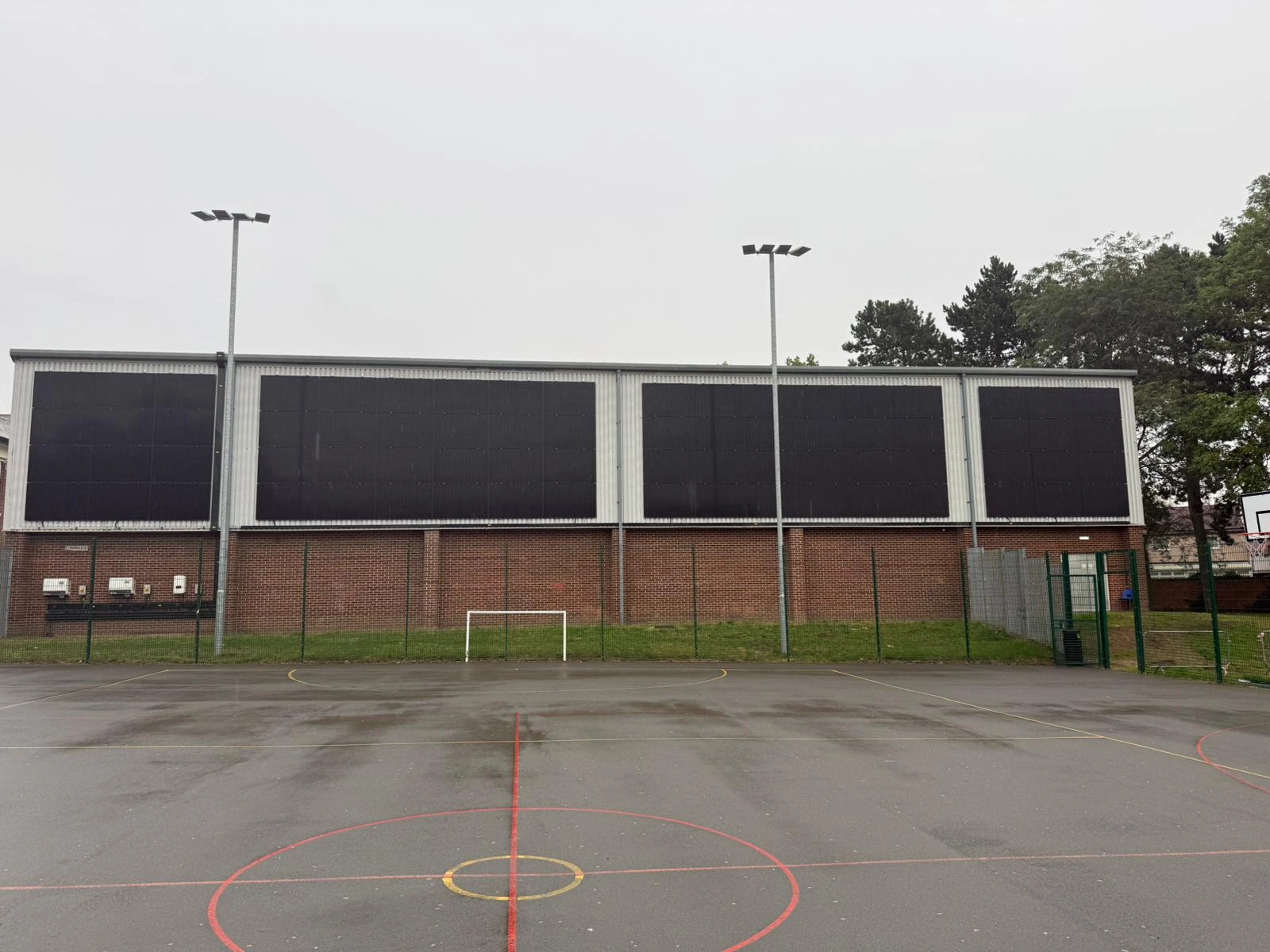 PV facade panels above brickwork on a Deeside sports building installed by MARA Electrical, MCS certified solar installers