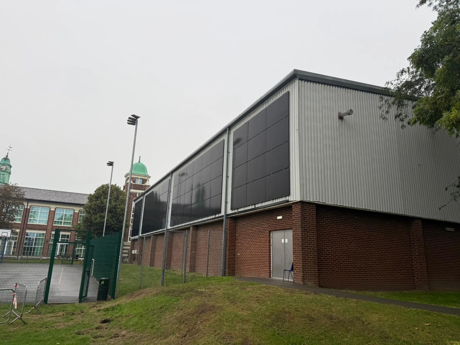 Corner view of the PV facade installation on a Deeside leisure building by MARA Electrical — building-integrated solar Flintshire